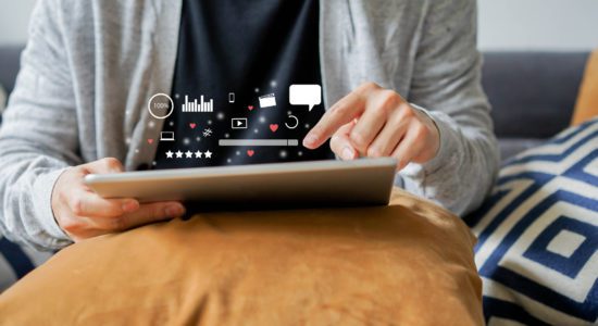 close up on man holding tablet to play entertainment or using website to search on internet of social media marketing for iot lifestyle and business network technology business concept